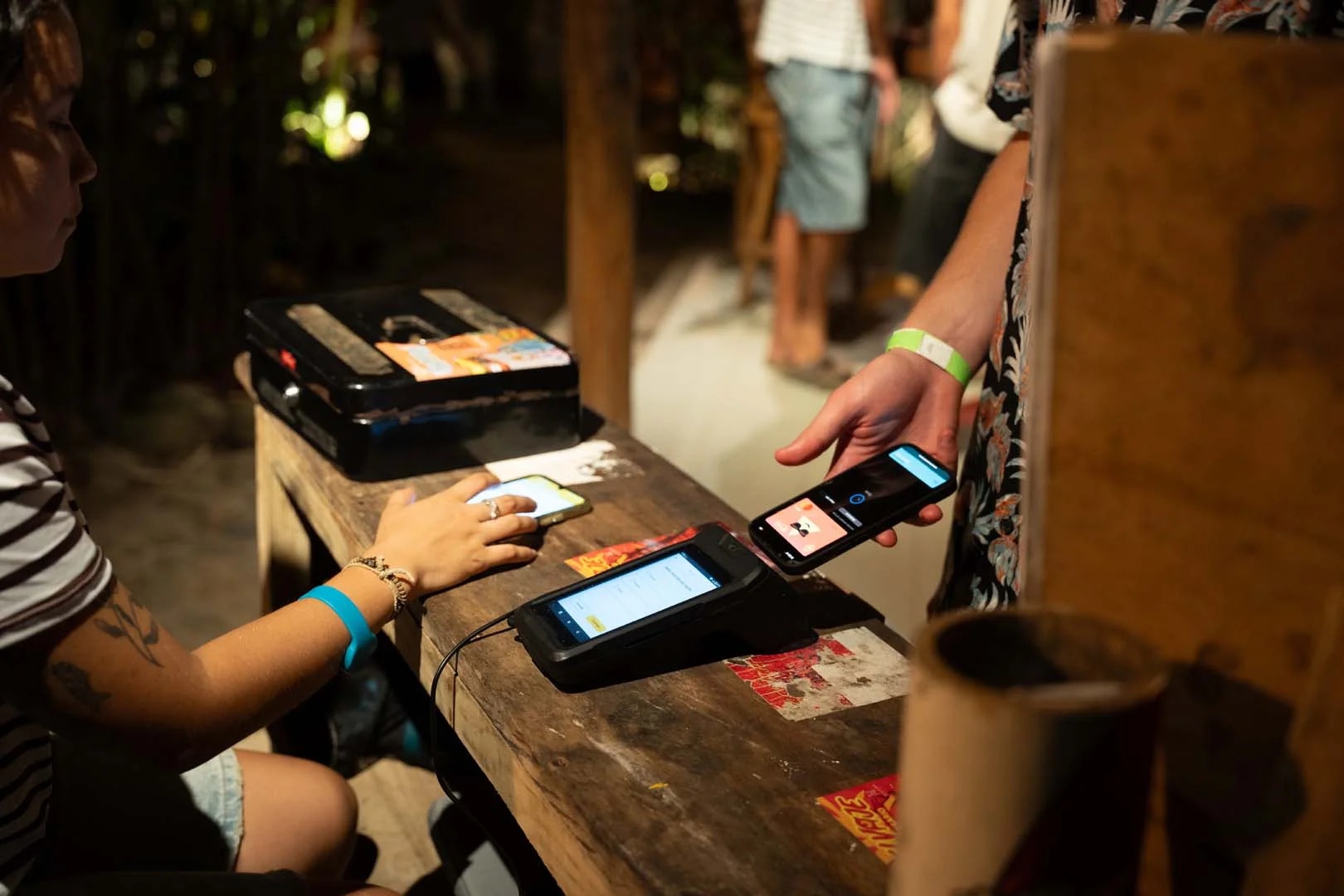 Man is paying with his phone at the hostel reception